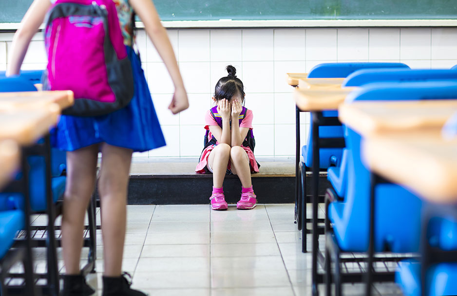 Little girl bullying in school classroom.