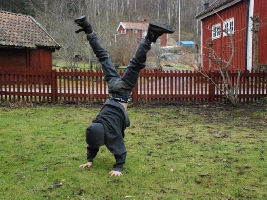 Boy doing cartwheel in yard